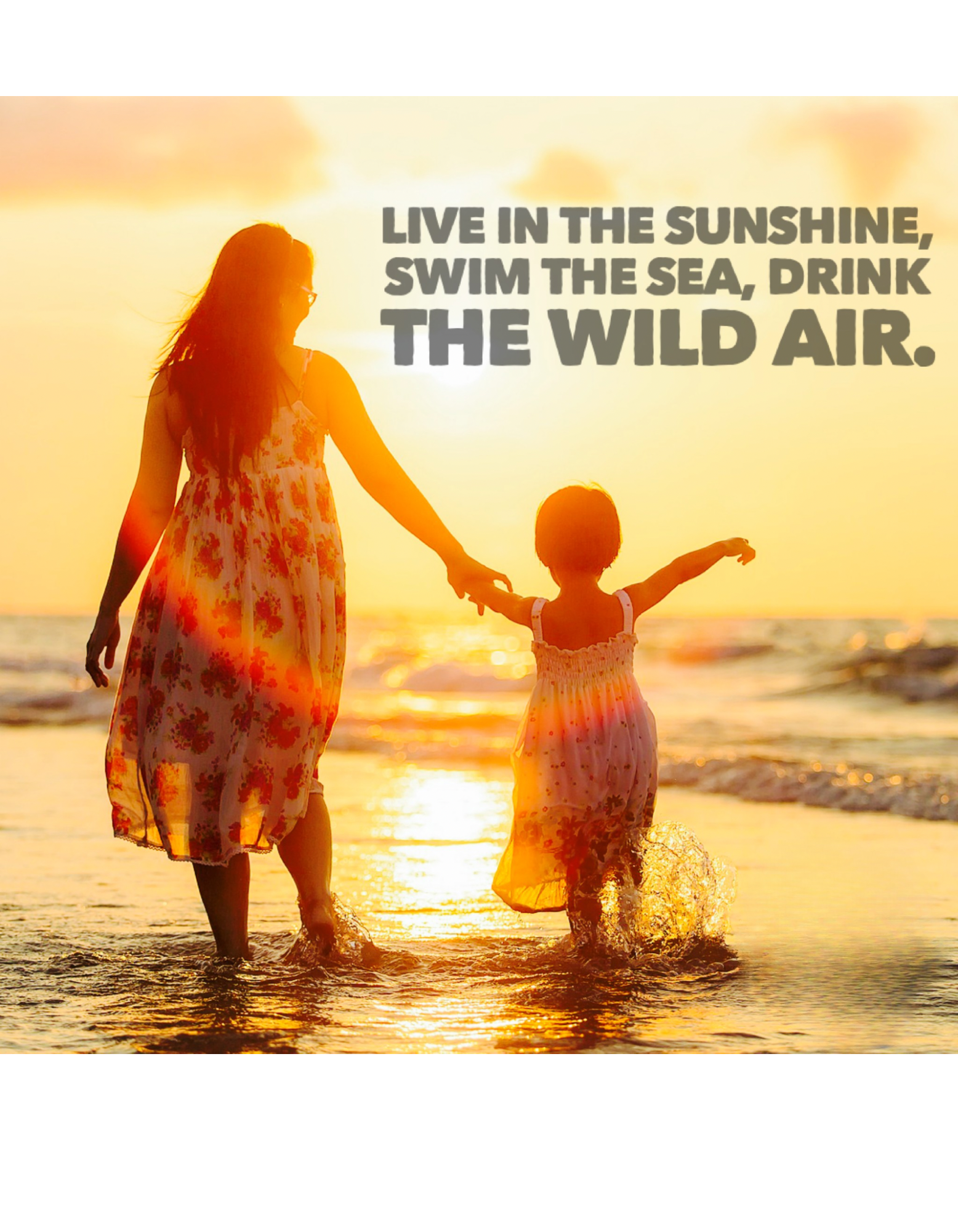 Mother and child walking on the beach at sunset